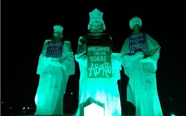 Protesto pró-aborto picha outdoor e posiciona cartazes em imgens de Reis Magos